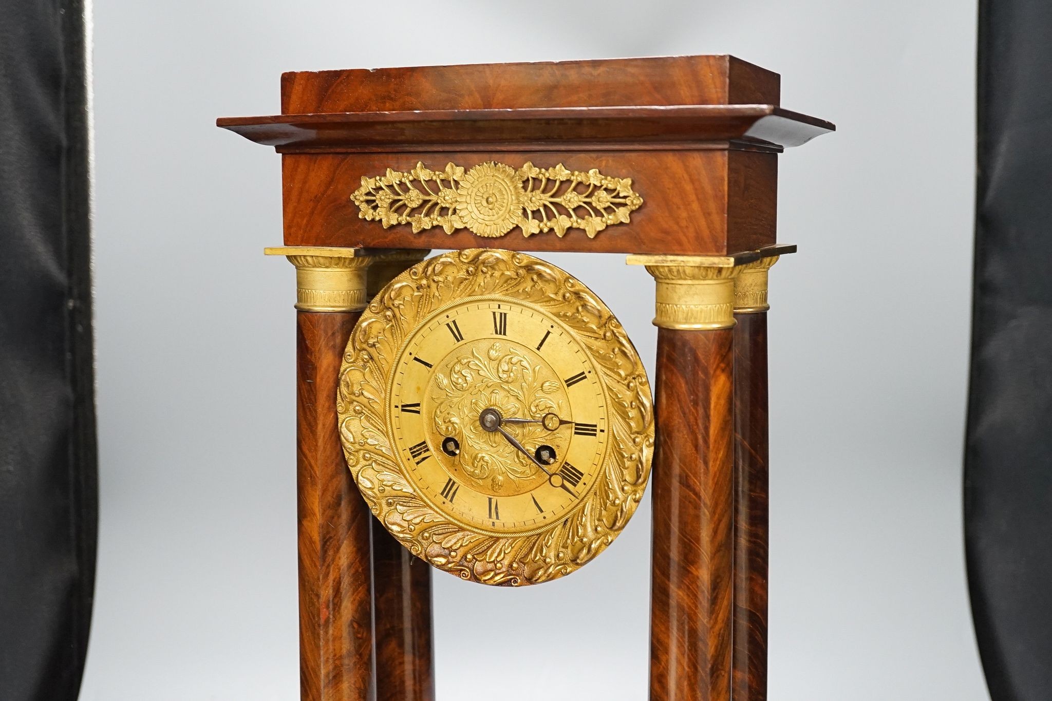 An early 19th century mahogany portico clock with three keys and spare bell, 50cm